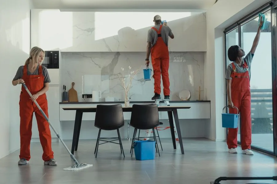 Professional cleaning crew working through a bright modern space